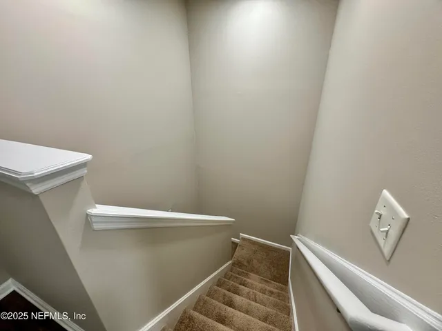 a view of an empty room with a ceiling fan