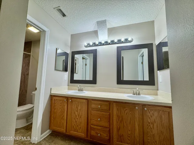 an empty room with closet and a ceiling fan