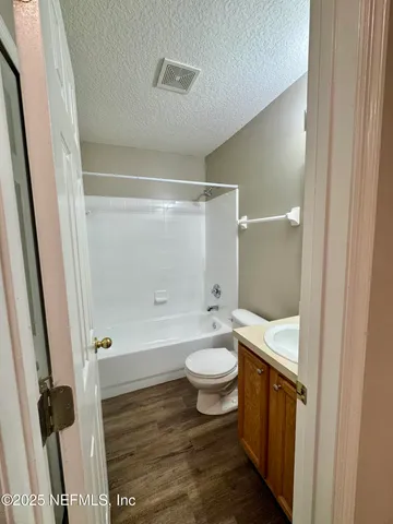 an empty room with a window and a ceiling fan