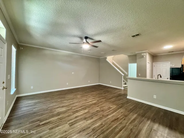 a view of a kitchen with a sink and a ceiling fan