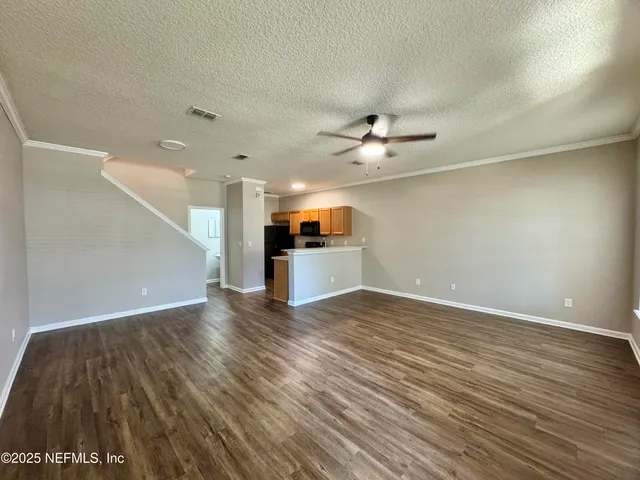 a kitchen with stainless steel appliances a refrigerator and microwave