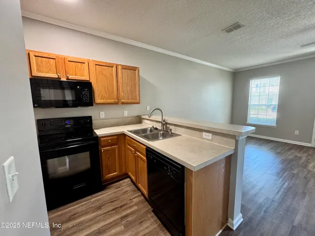 a kitchen with a refrigerator stove and sink