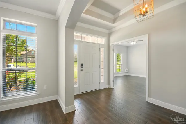 a view of a hallway with wooden floor and a window