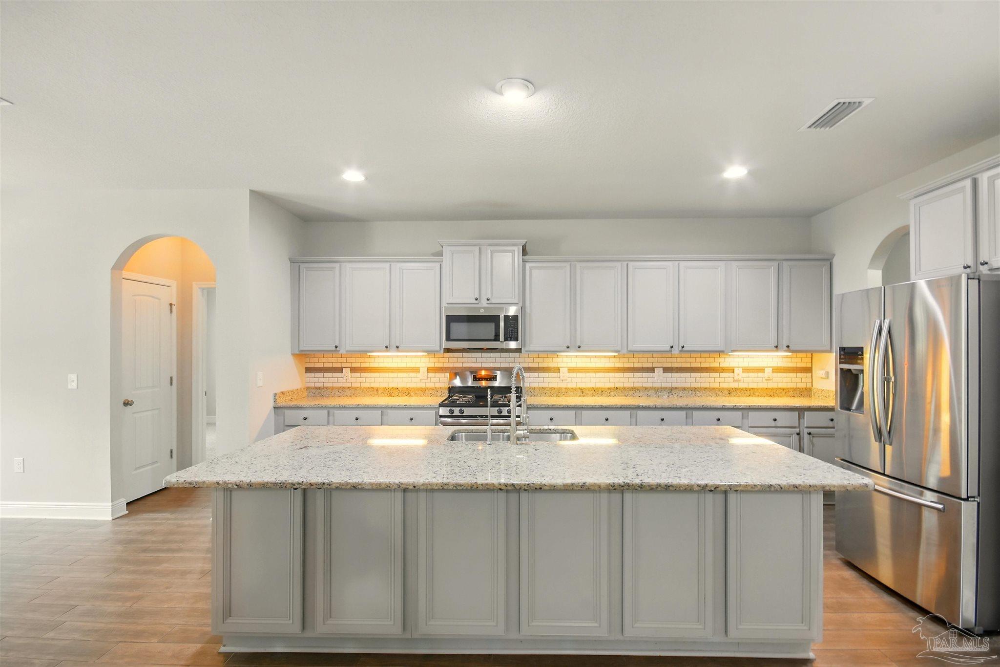 2701 Tulip Hill Road Pace, FL 32571 - Photo 11 of 42 a kitchen with a refrigerator a stove and a sink