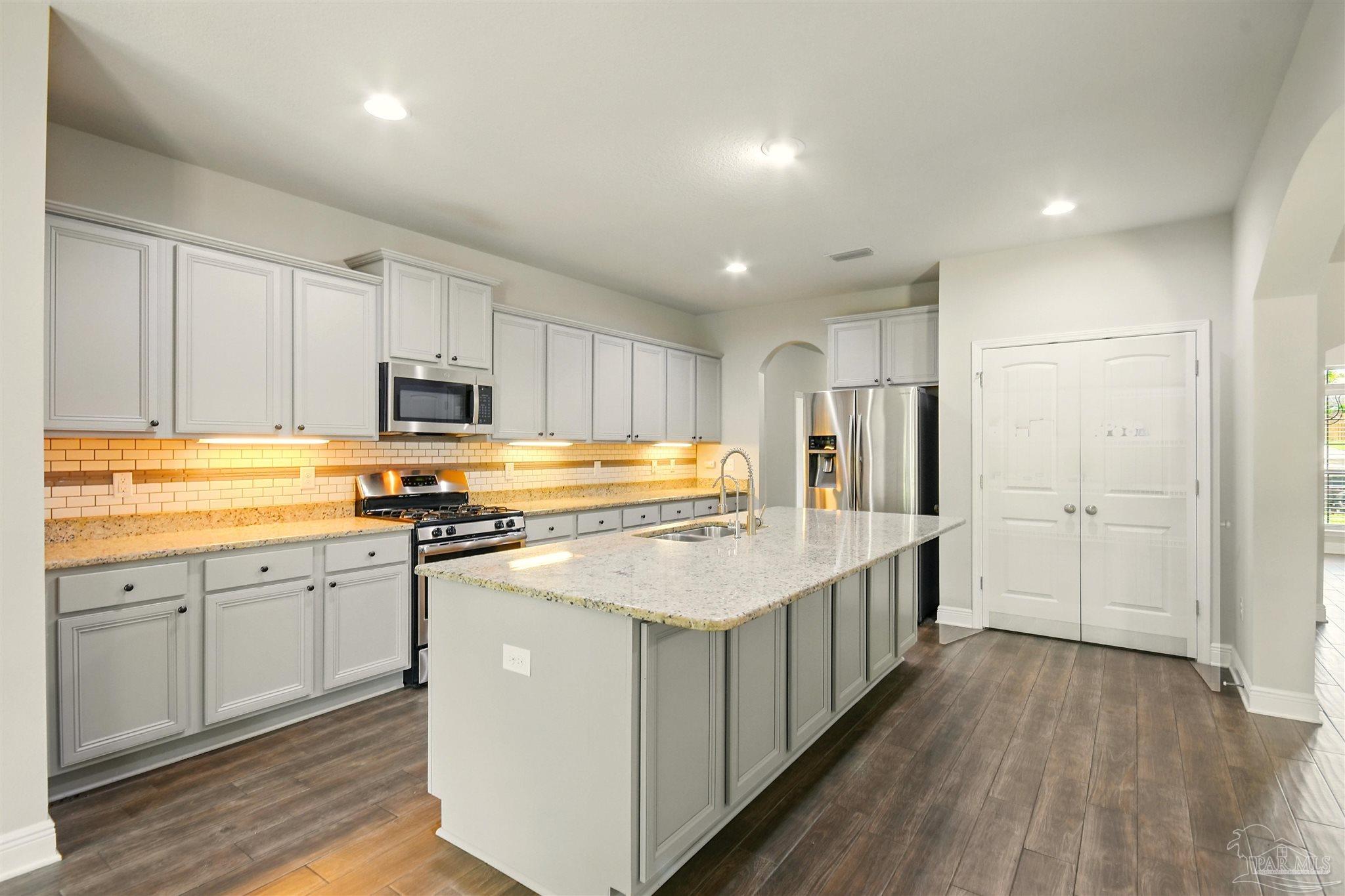 2701 Tulip Hill Road Pace, FL 32571 - Photo 13 of 42 a kitchen with appliances a sink and cabinets