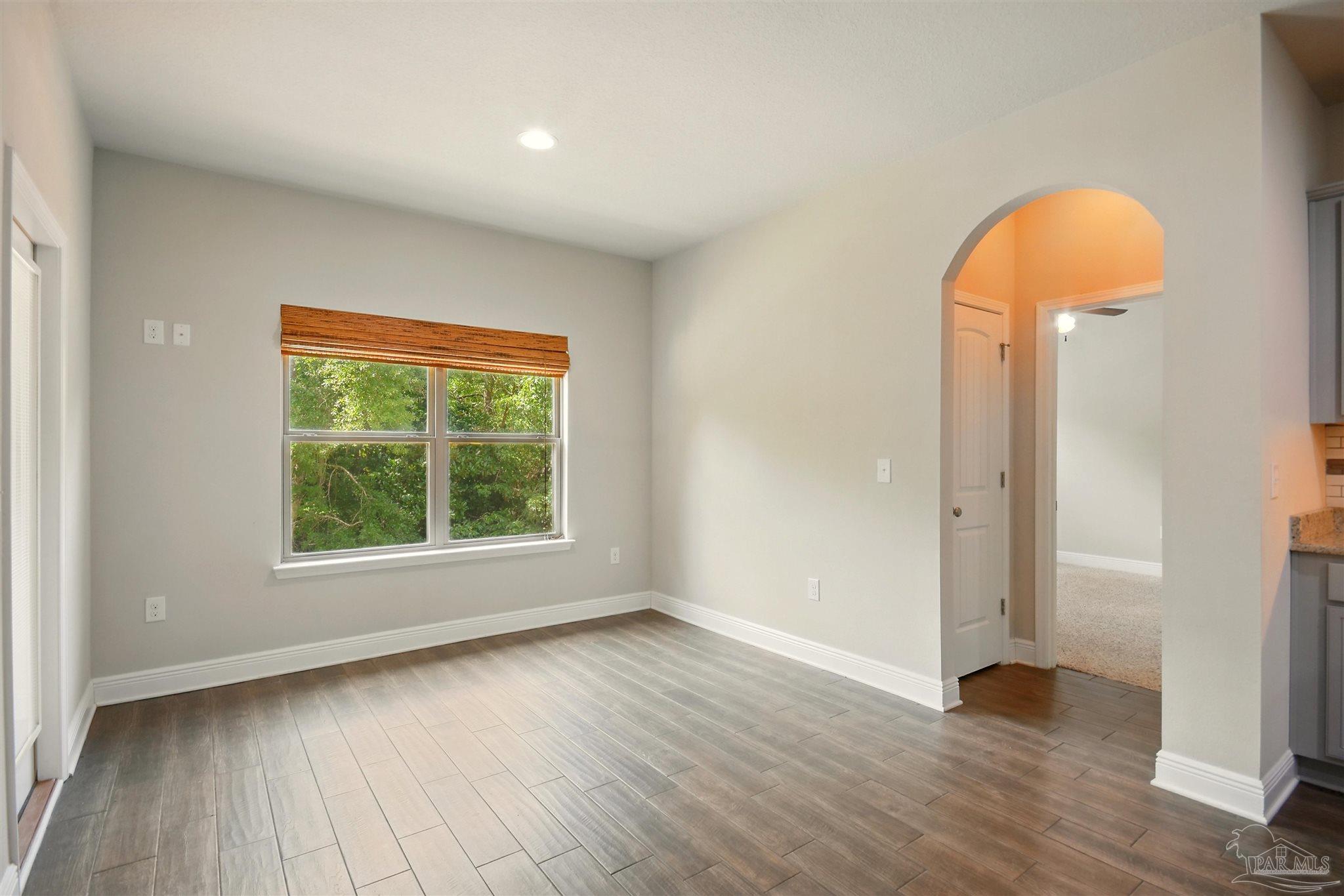 2701 Tulip Hill Road Pace, FL 32571 - Photo 16 of 42 an empty room with wooden floor and a window