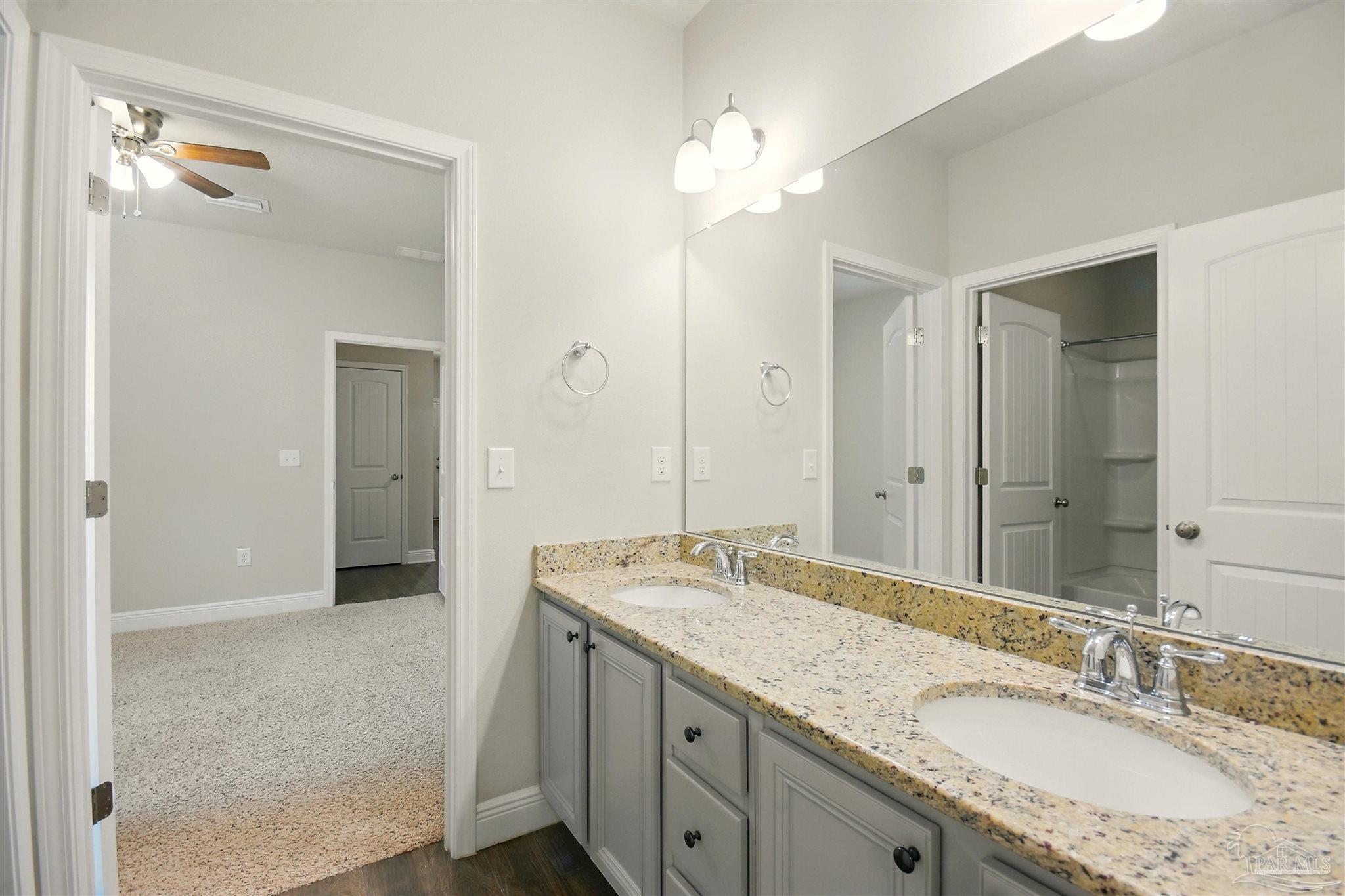 2701 Tulip Hill Road Pace, FL 32571 - Photo 20 of 42 a bathroom with a granite countertop sink and a mirror