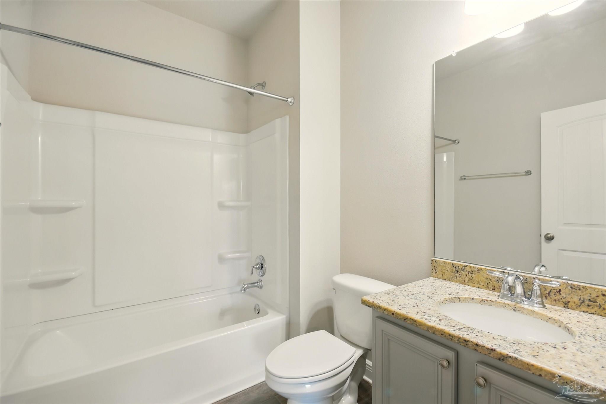 2701 Tulip Hill Road Pace, FL 32571 - Photo 26 of 42 a bathroom with a granite countertop sink a toilet and shower