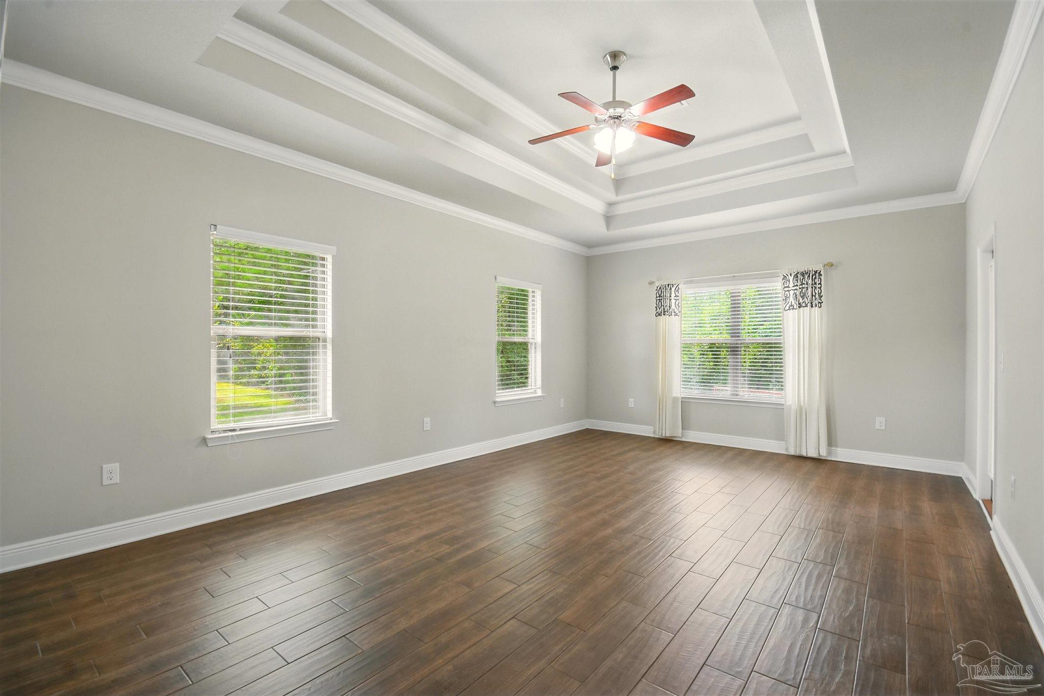 2701 Tulip Hill Road Pace, FL 32571 - Photo 28 of 42 a view of an empty room with wooden floor and a window