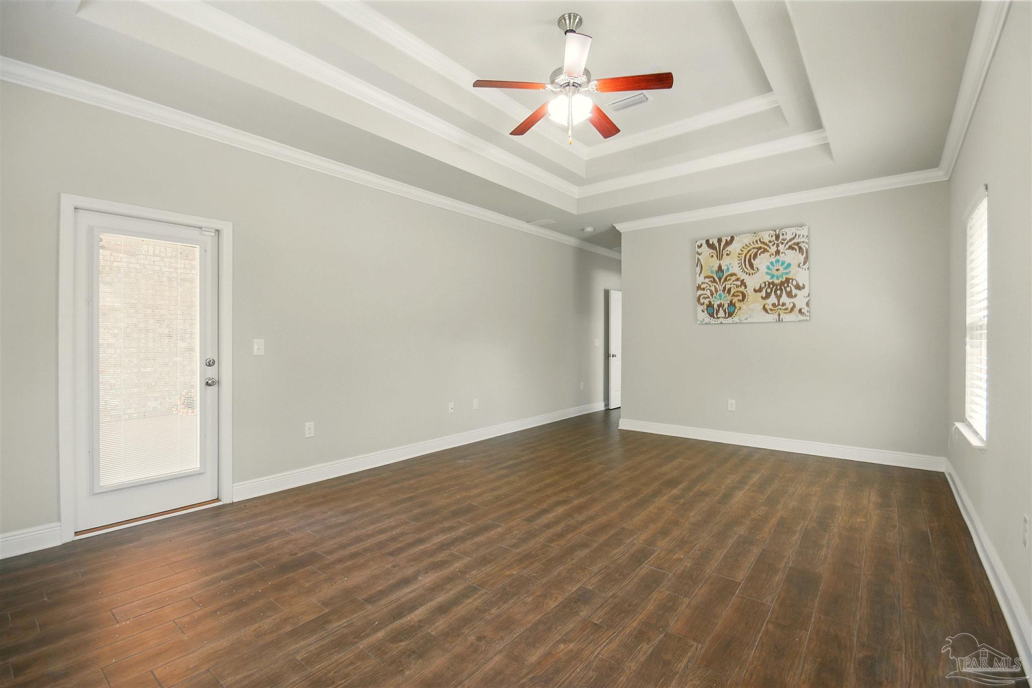 2701 Tulip Hill Road Pace, FL 32571 - Photo 29 of 42 an empty room with wooden floor and ceiling fan