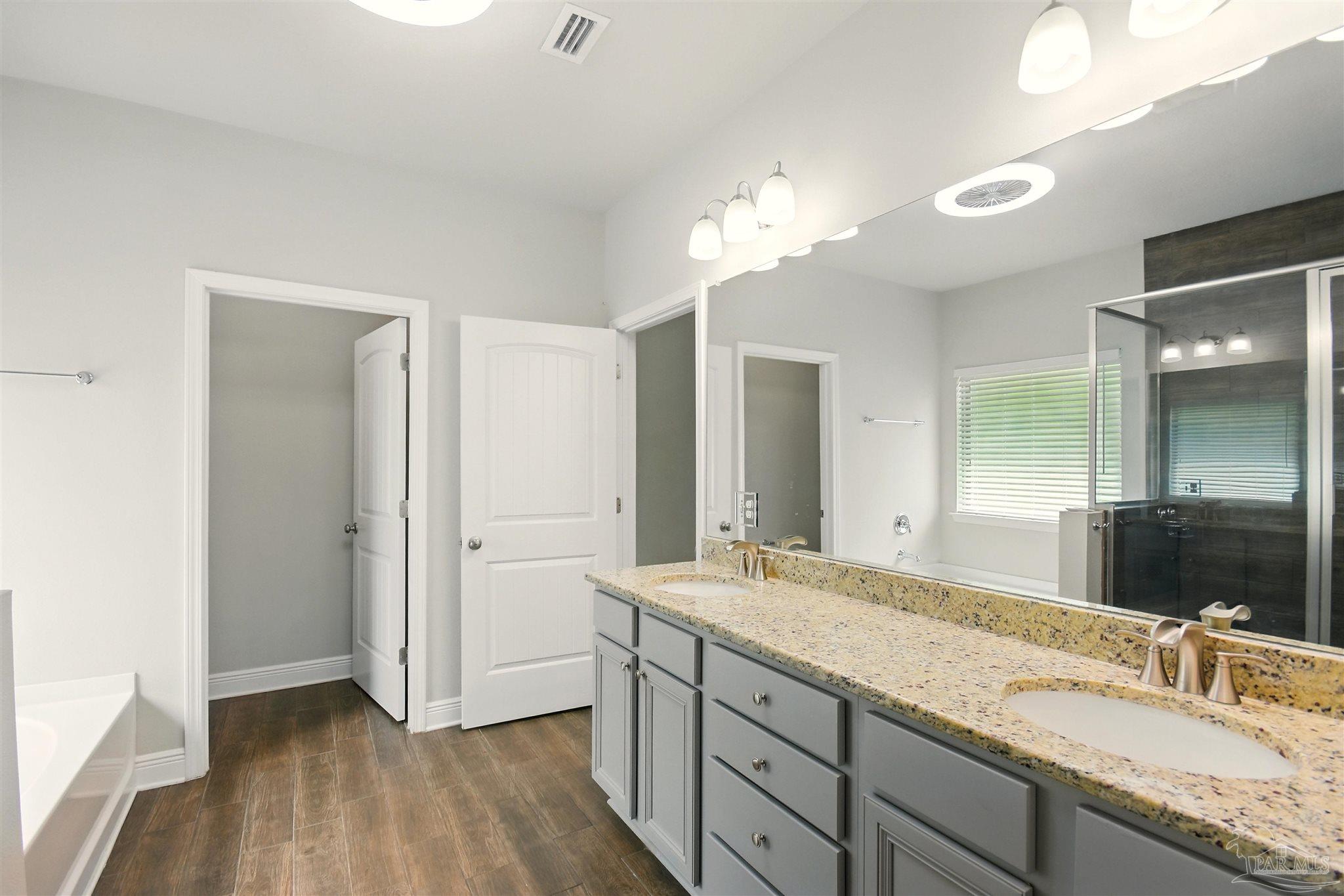 2701 Tulip Hill Road Pace, FL 32571 - Photo 31 of 42 a bathroom with a granite countertop sink and a mirror