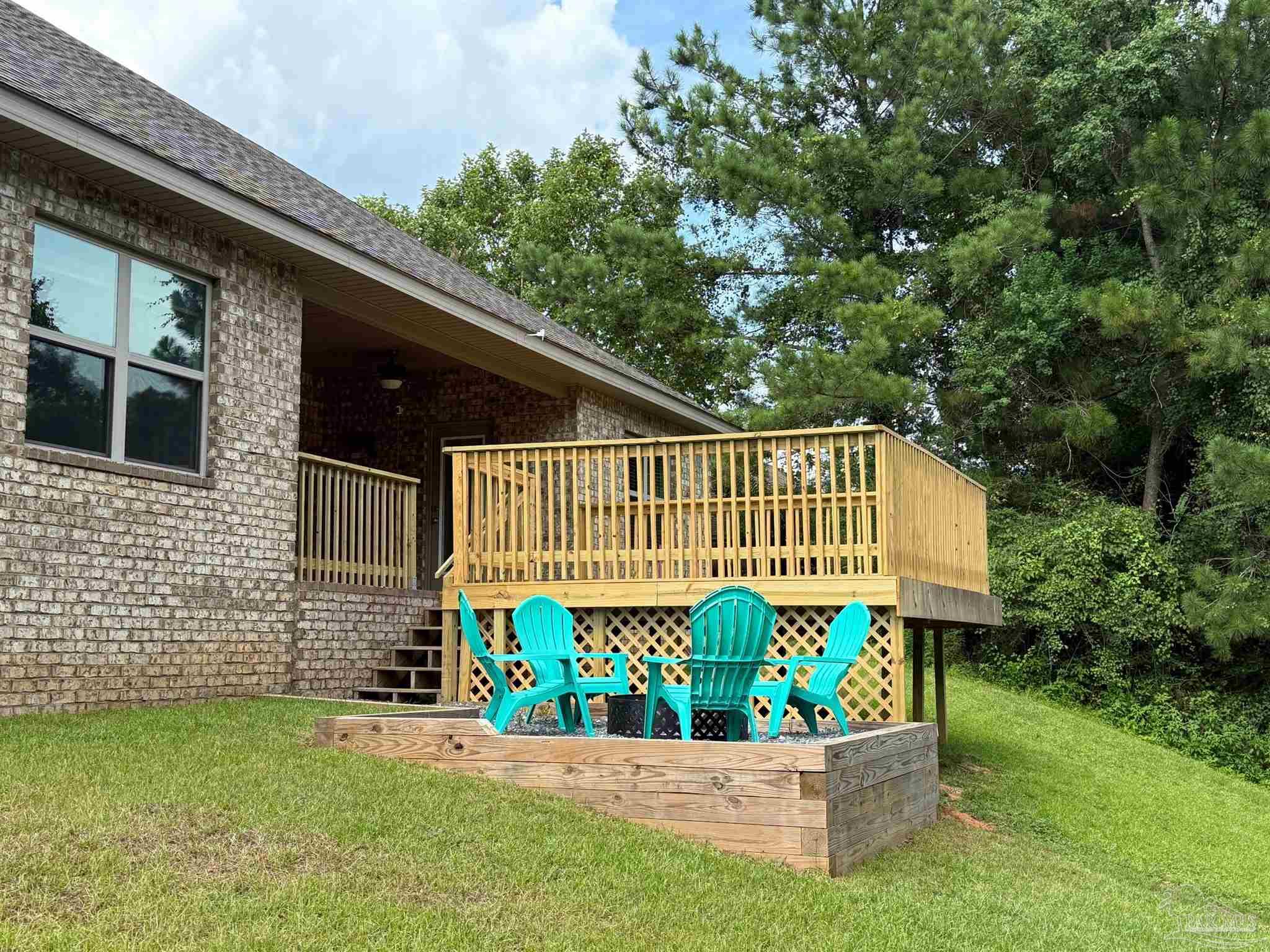 2701 Tulip Hill Road Pace, FL 32571 - Photo 37 of 42 a view of a chair and table in the patio