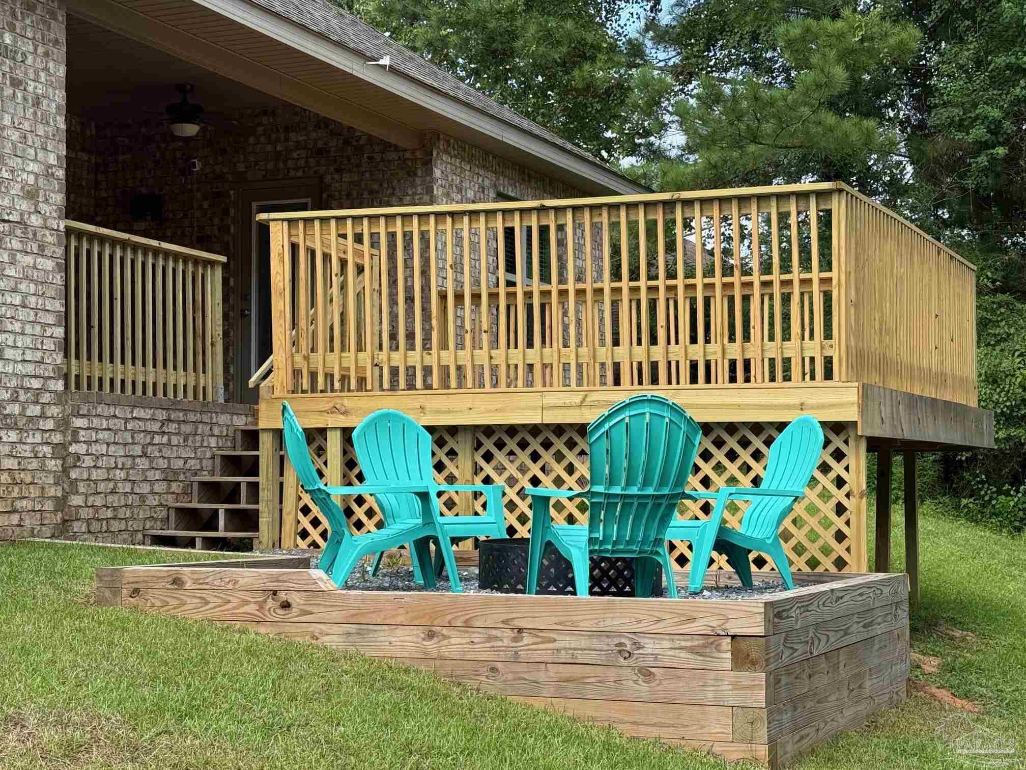 2701 Tulip Hill Road Pace, FL 32571 - Photo 39 of 42 a front view of a house with a yard and potted plants