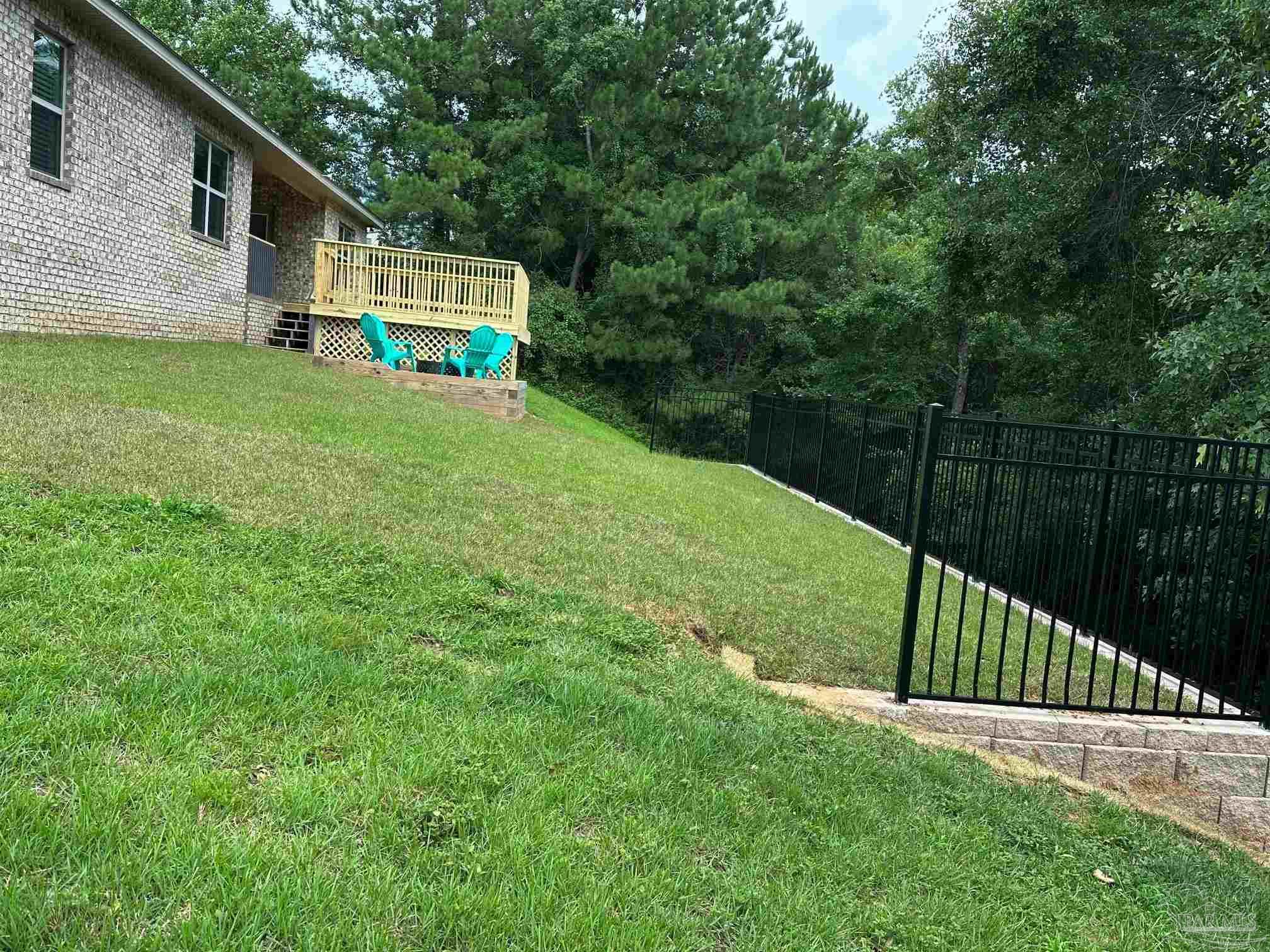 2701 Tulip Hill Road Pace, FL 32571 - Photo 40 of 42 a view of a backyard with a small cabin