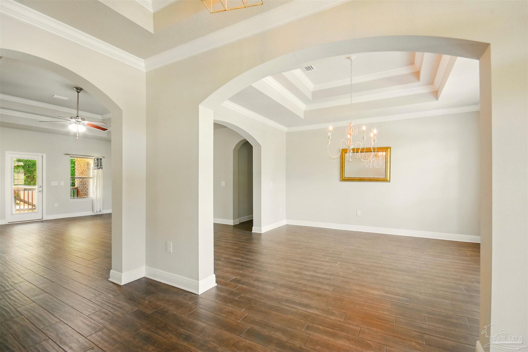 2701 Tulip Hill Road Pace, FL 32571 - Photo 4 of 42 a view of an empty room with wooden floor and a window