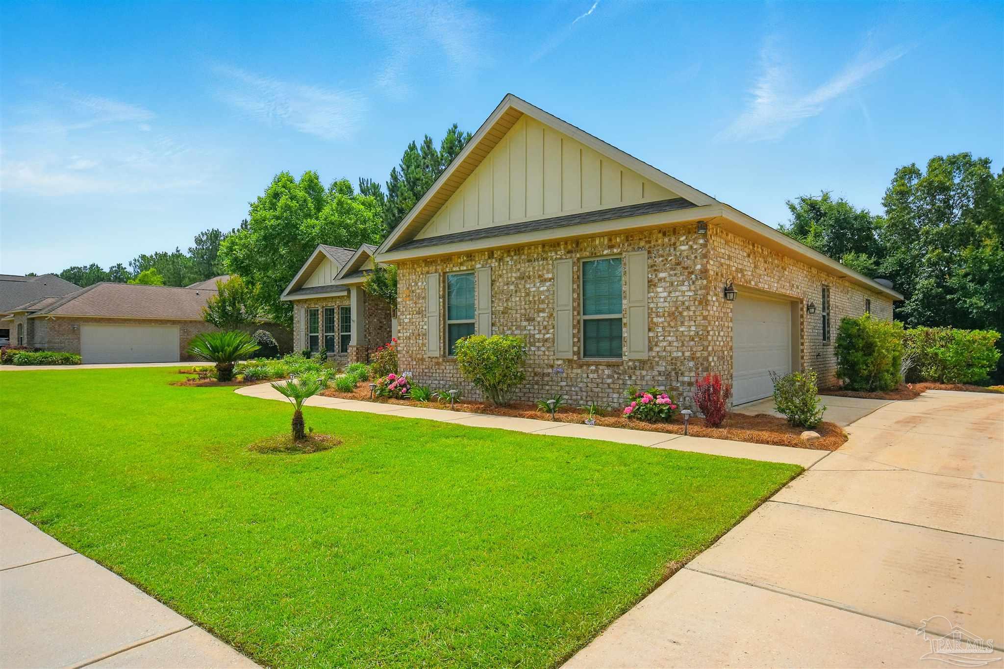 2701 Tulip Hill Road Pace, FL 32571 - Photo 42 of 42 a front view of house with a garden and yard