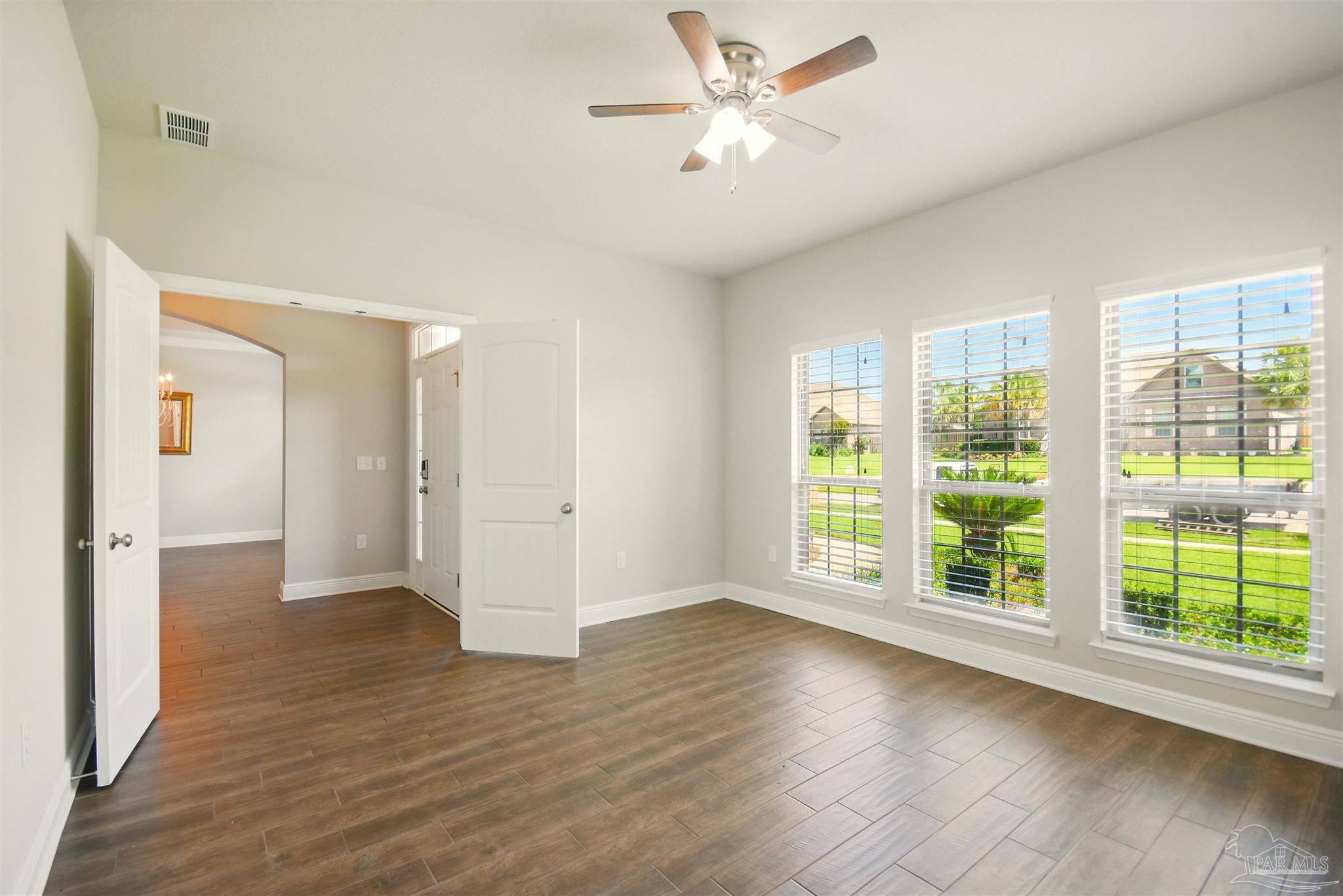 2701 Tulip Hill Road Pace, FL 32571 - Photo 7 of 42 a view of an empty room with a window and wooden floor