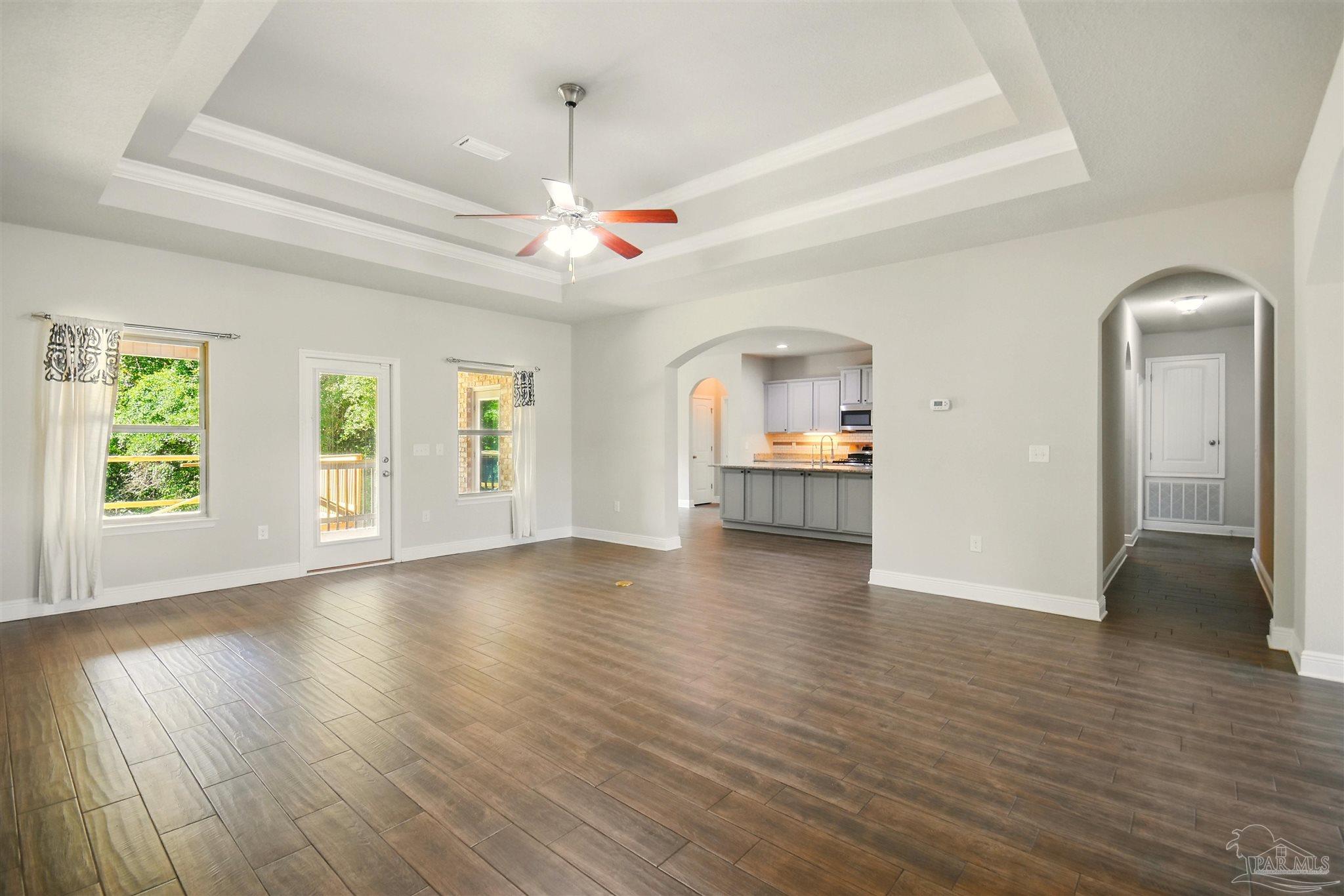 2701 Tulip Hill Road Pace, FL 32571 - Photo 8 of 42 a view of a livingroom with hardwood floor and a ceiling fan