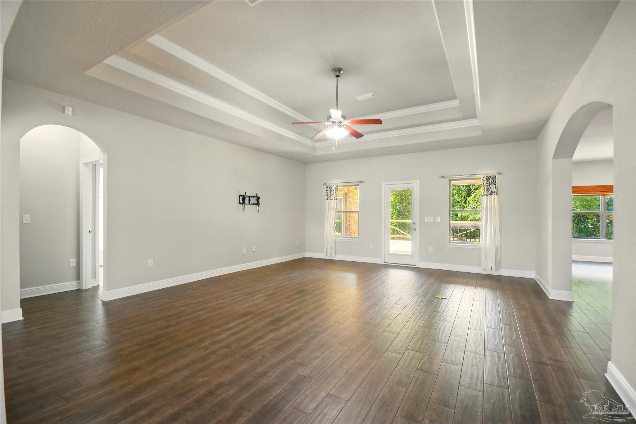 2701 Tulip Hill Road Pace, FL 32571 - Photo 9 of 42 an empty room with wooden floor and windows