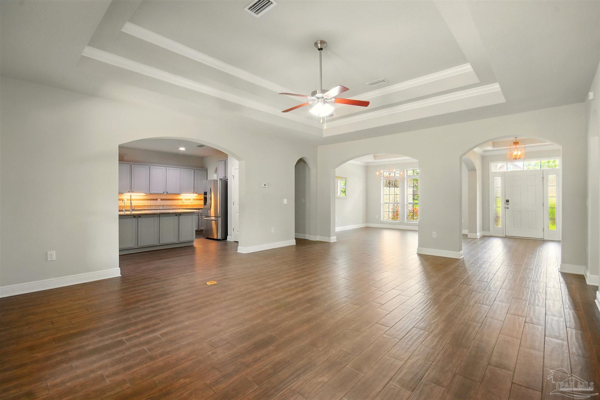 2701 Tulip Hill Road Pace, FL 32571 - Photo 10 of 42 an empty room with wooden floor and windows