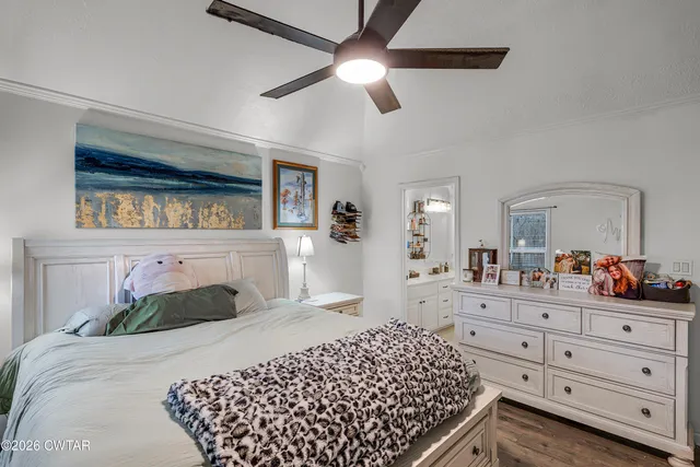 a bedroom with a bed and a dresser in it