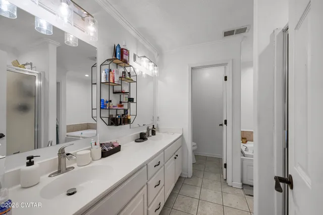 a bathroom with a sink double vanity and a mirror
