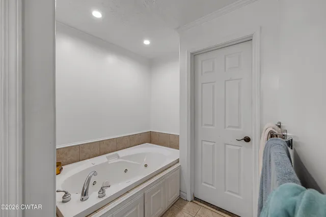 a bathroom with a tub a sink and vanity