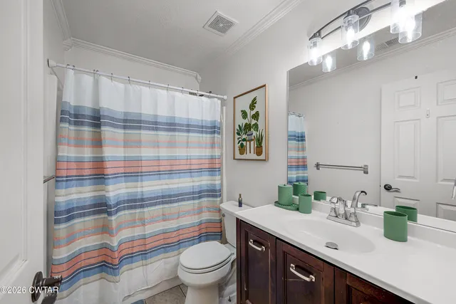 a bathroom with a sink a toilet a shower and a mirror