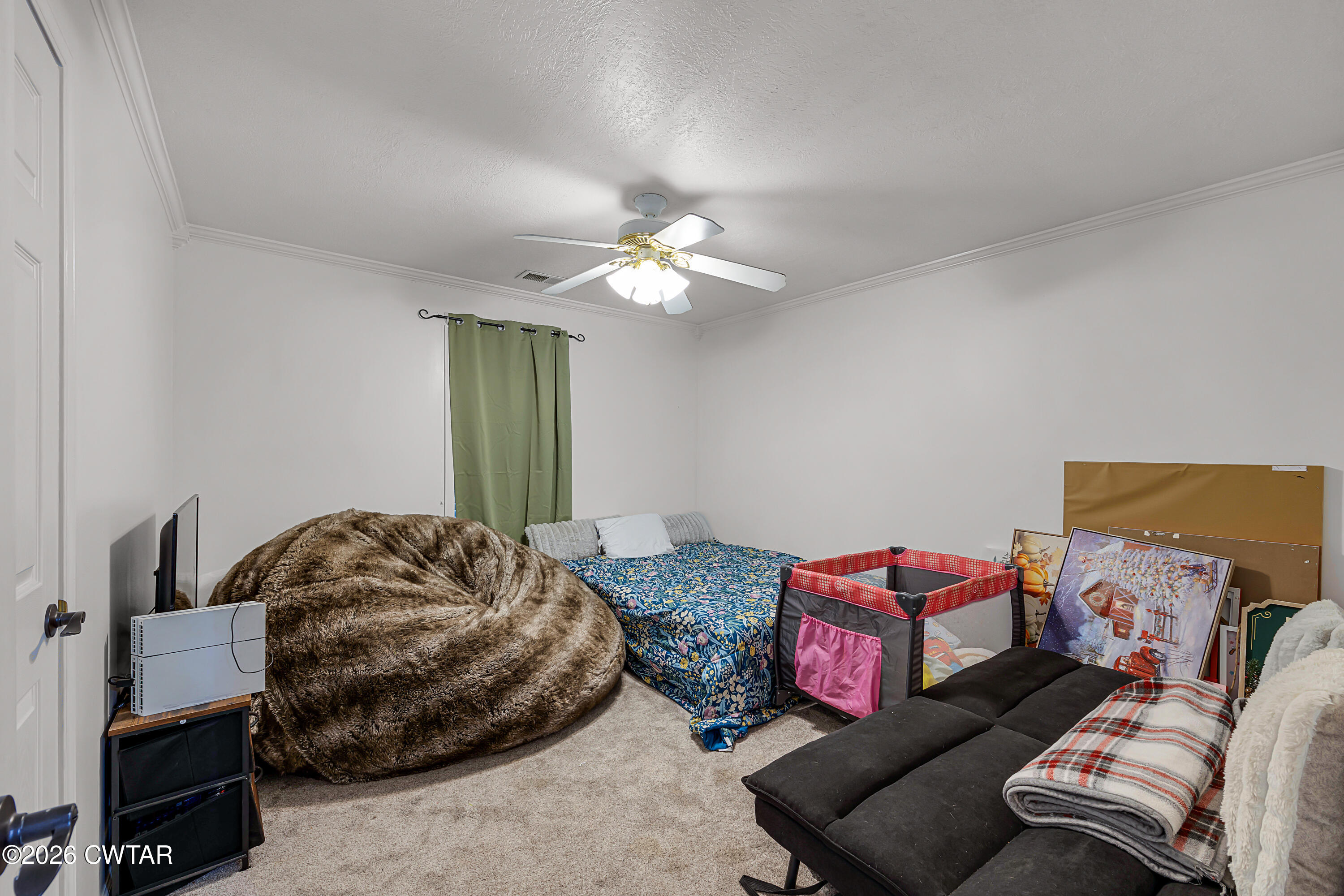 23 Matrix Cove Jackson, TN 38305 - Photo 16 of 19 a bedroom with a bed and a chandelier