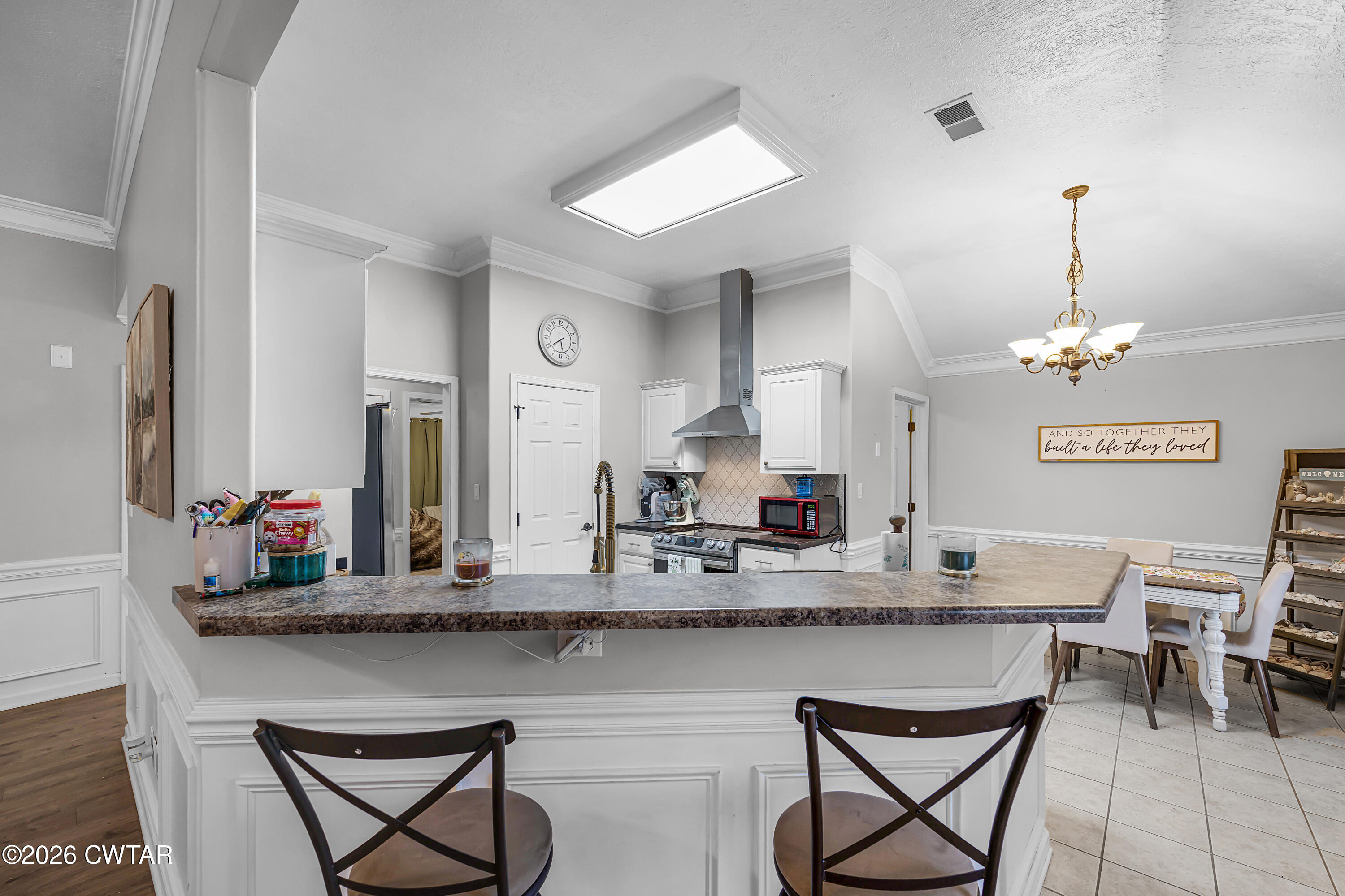 23 Matrix Cove Jackson, TN 38305 - Photo 6 of 19 a kitchen with stainless steel appliances granite countertop a kitchen island and chairs in it