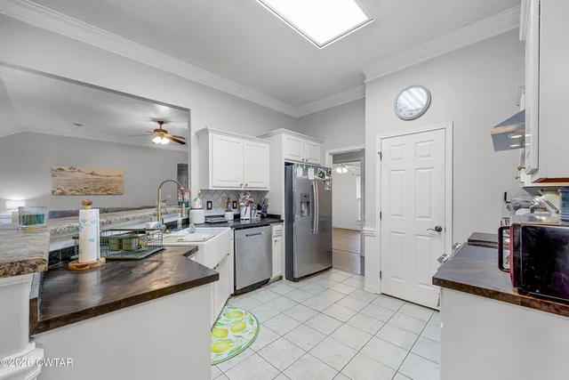 a kitchen with refrigerator and cabinets
