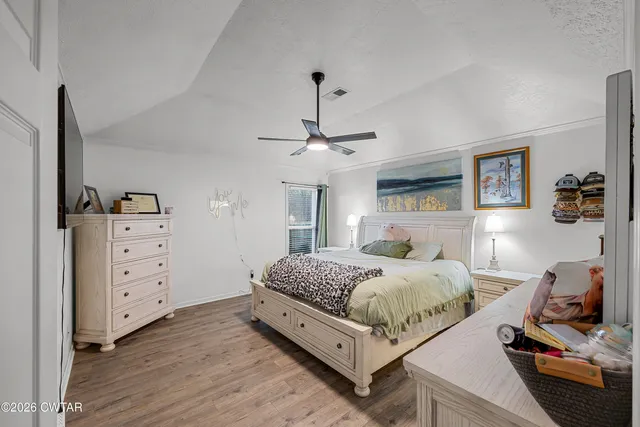 a room with a bed and a dresser