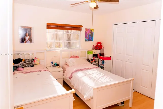 a room with two bed and a window