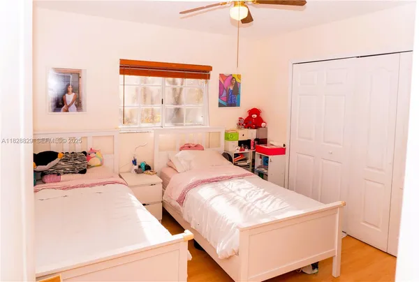 a room with two bed and a window