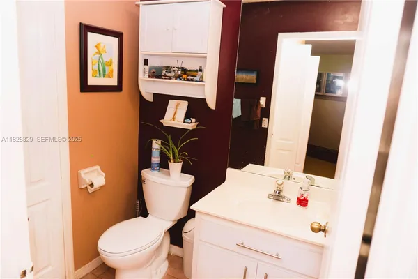 a white toilet sitting next to a bathroom sink