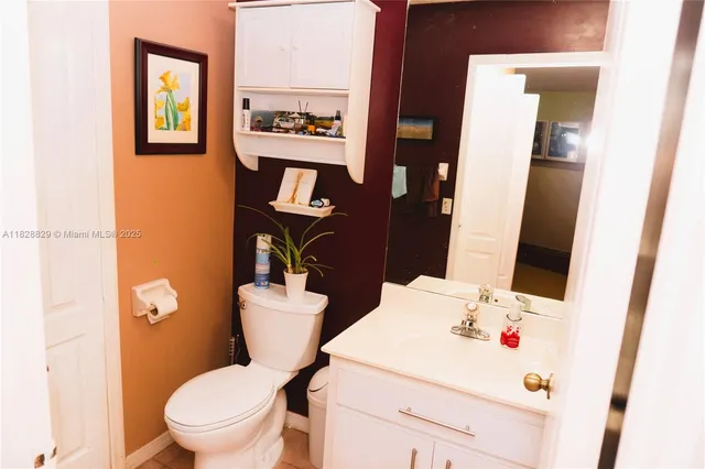 a white toilet sitting next to a bathroom sink