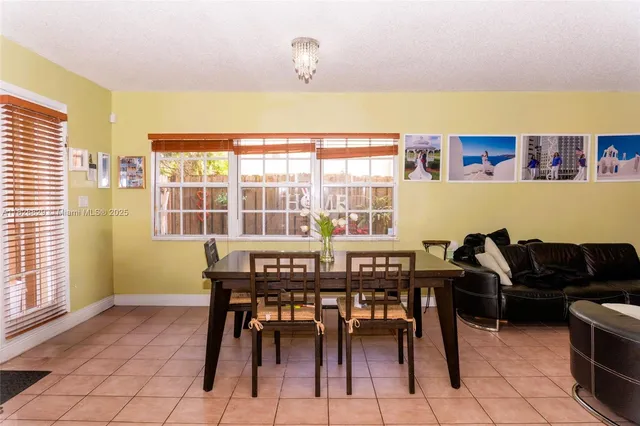 a view of a dining room with furniture and a window