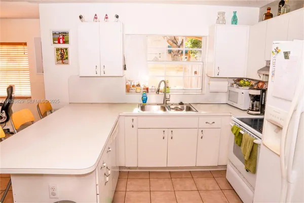 a utility room with cabinets washer and dryer