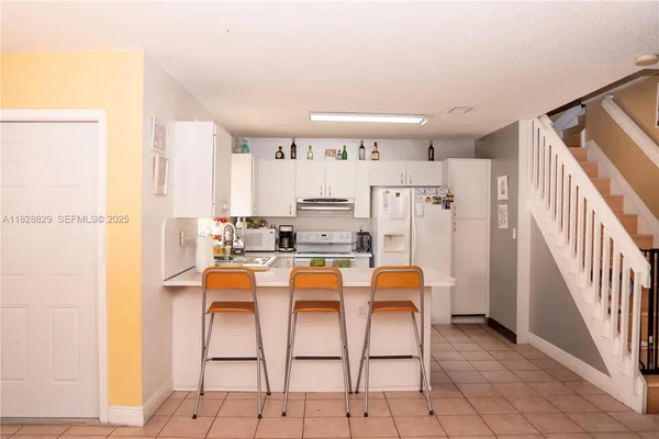 a dining room with furniture and a window