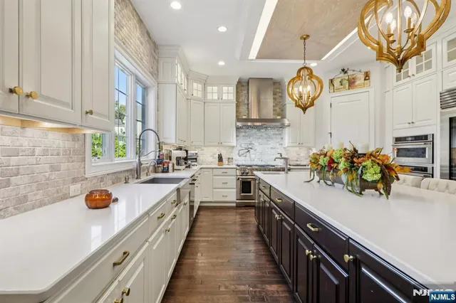 a kitchen with a sink a stove cabinets and a window