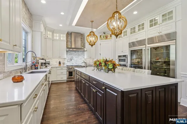 a kitchen with a sink appliances and cabinets