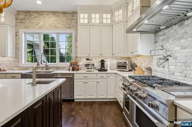 a kitchen with a sink stove top oven and cabinets