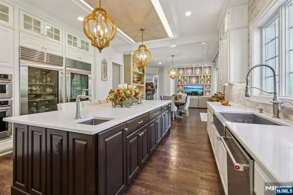 a kitchen with kitchen island granite countertop lots of counter top space and stainless steel appliances
