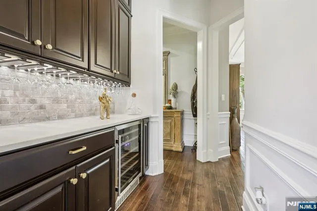 a kitchen with a sink and wooden floor