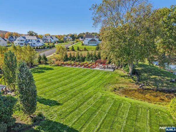 a aerial view of a house next to a yard