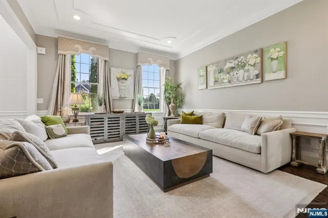 a living room with furniture and large windows