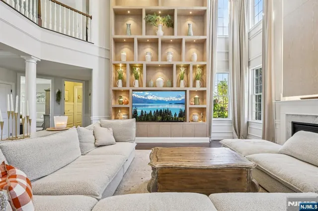 a living room with furniture kitchen view and a large window