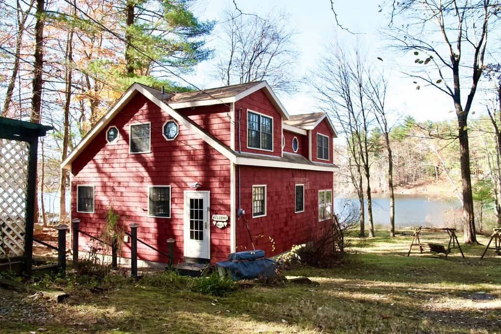 64 Lincoln Point Road Charlton, MA 01507 - Photo 1 of 28 a view of a house with a yard and a large tree