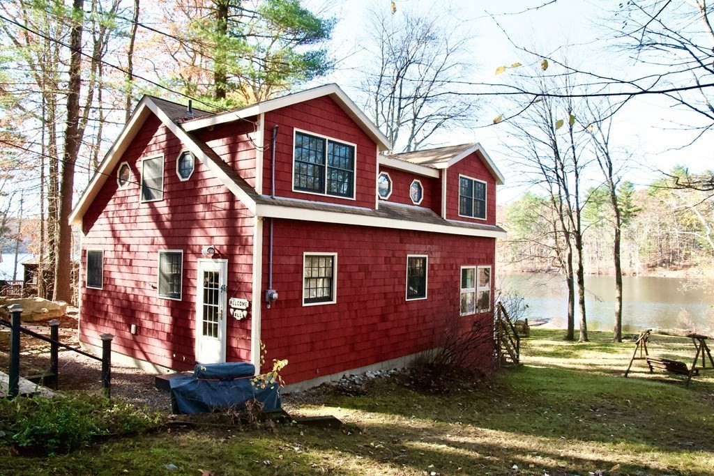 64 Lincoln Point Road Charlton, MA 01507 - Photo 27 of 28 a view of a brick house with a yard