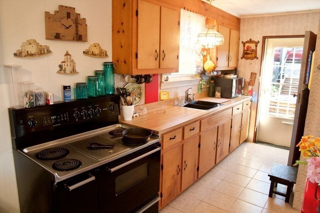 64 Lincoln Point Road Charlton, MA 01507 - Photo 6 of 28 a kitchen with a stove and a sink